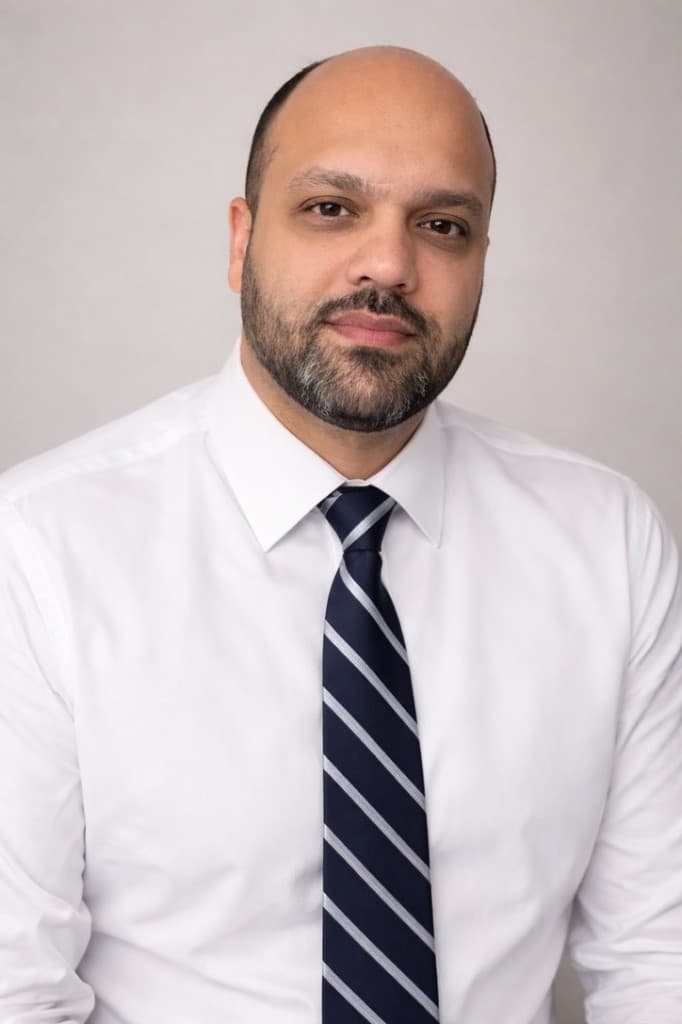Moe Bayat, founder of SimBay AI — professional headshot in white shirt and navy tie